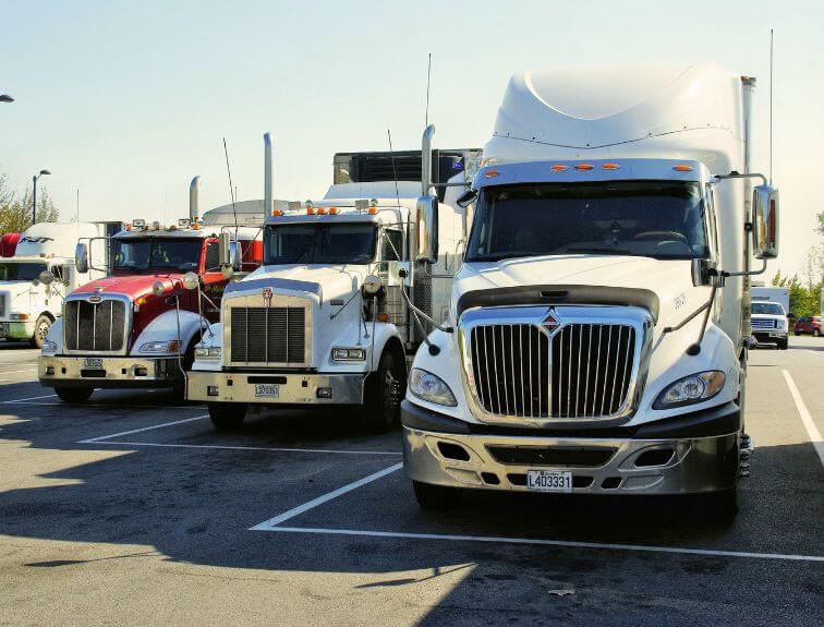 image of three trucks parked in a line